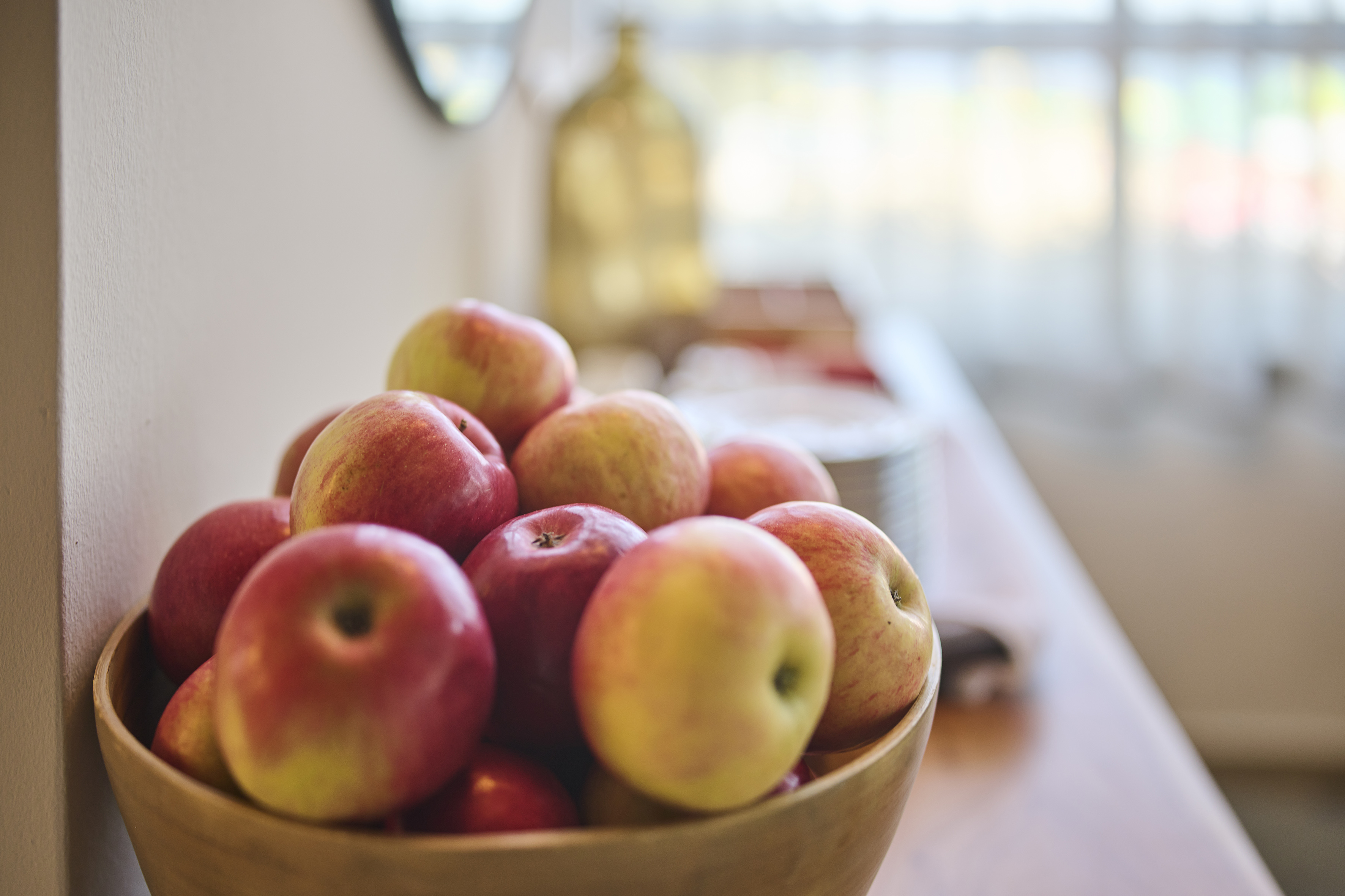 a bowl of apples on a table