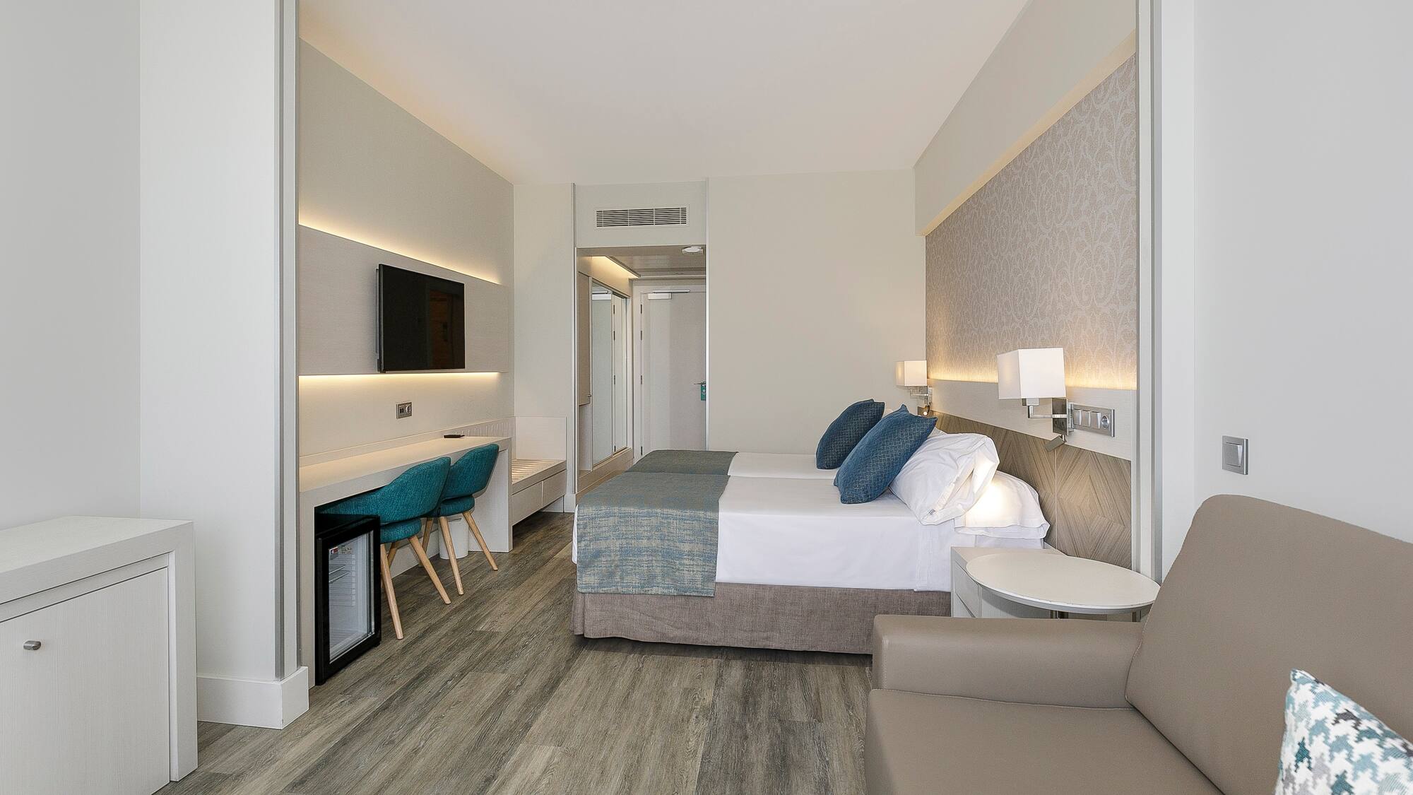 a room with a bed and a tv