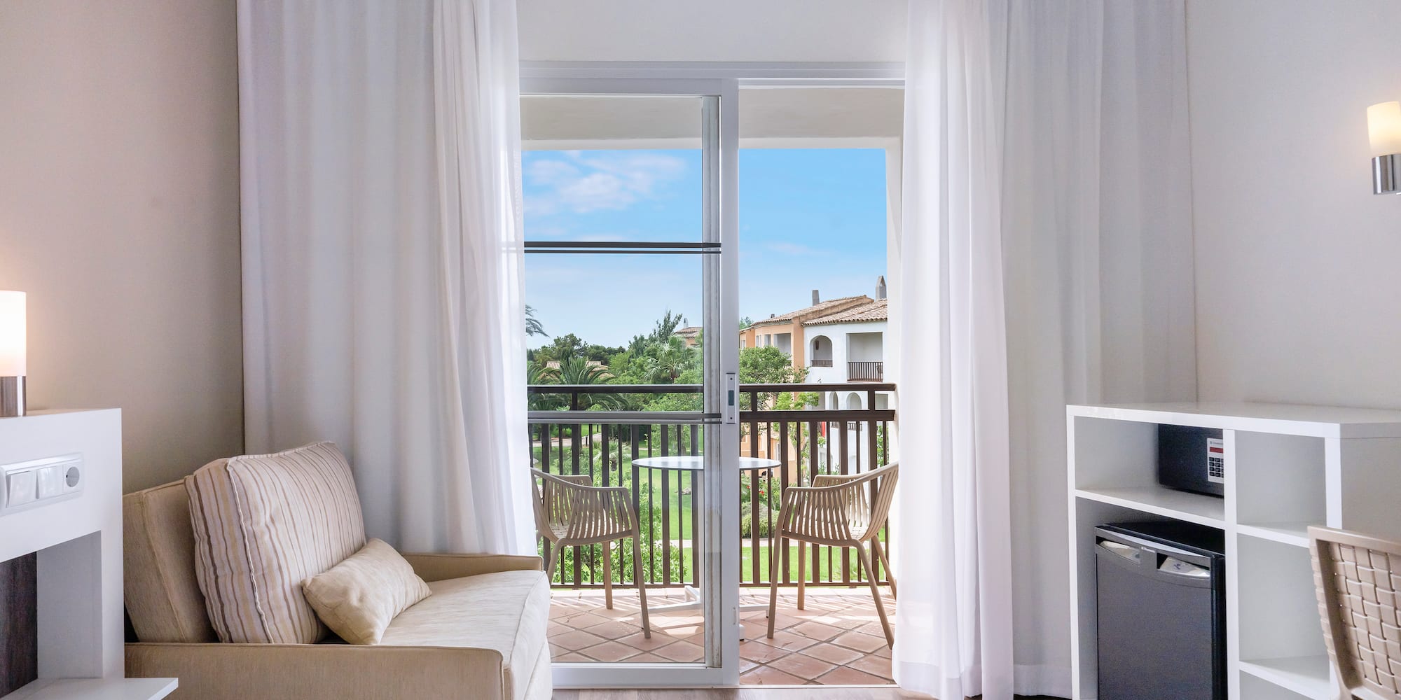 a room with a bed and a television and a balcony