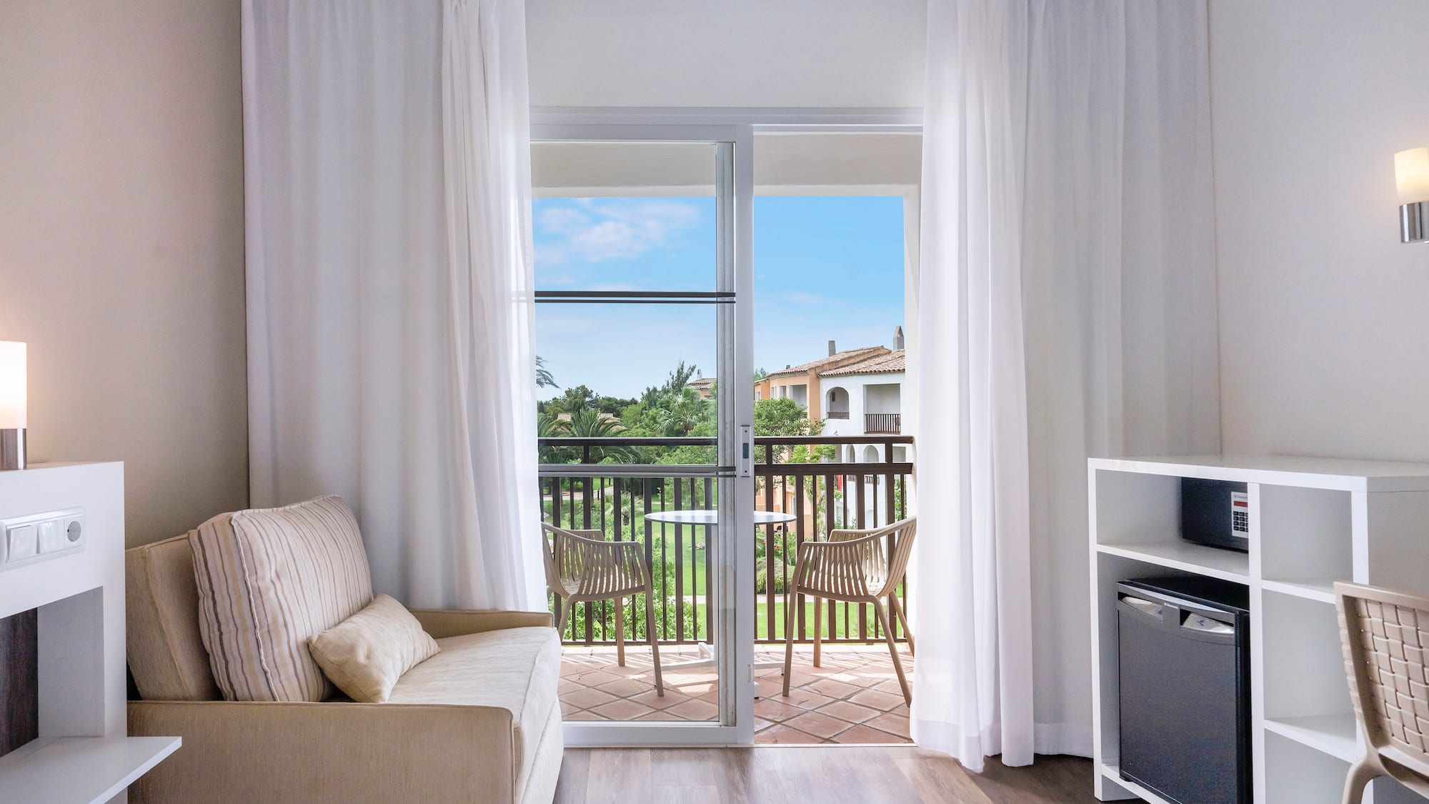 a room with a bed and a television and a balcony
