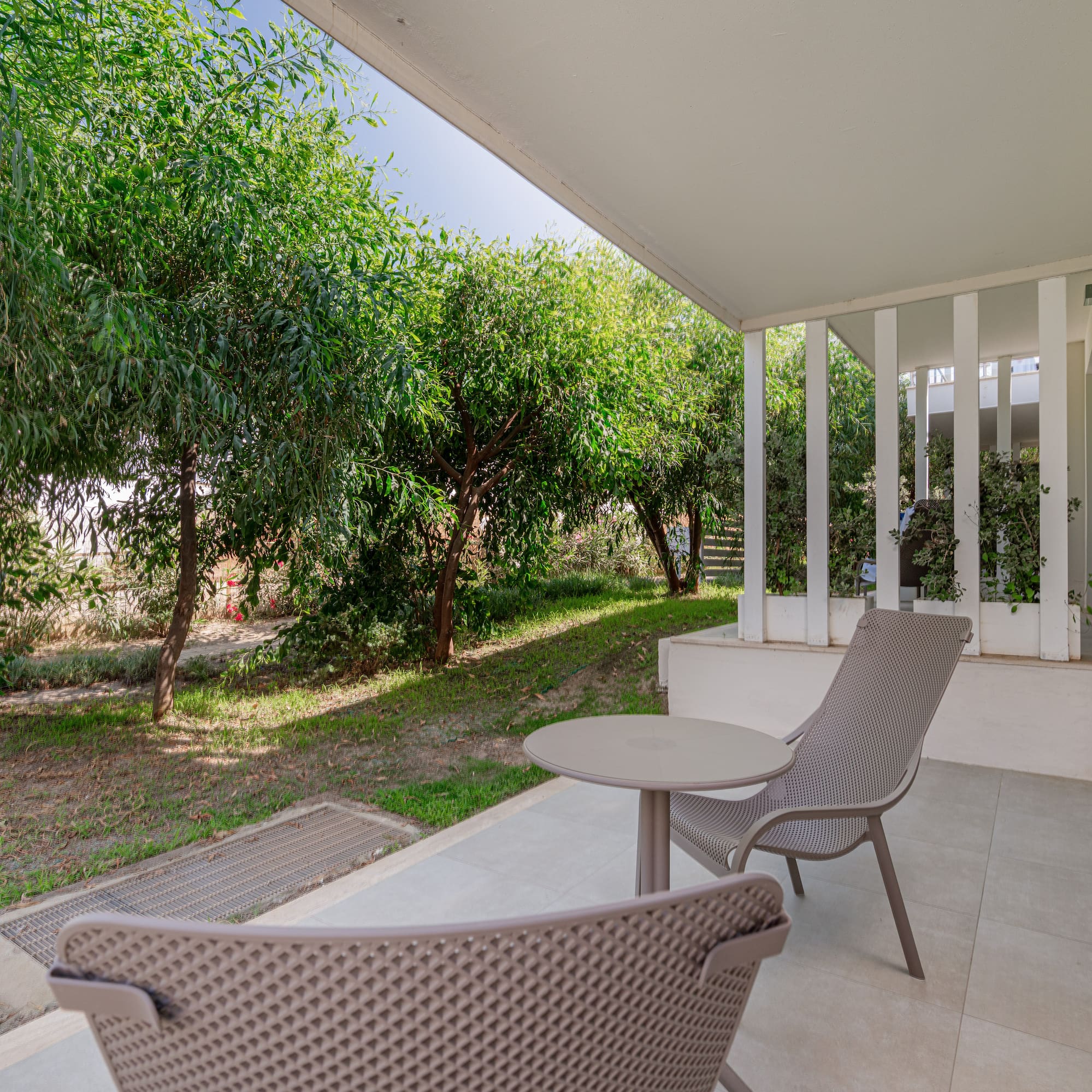 a patio with chairs and a table