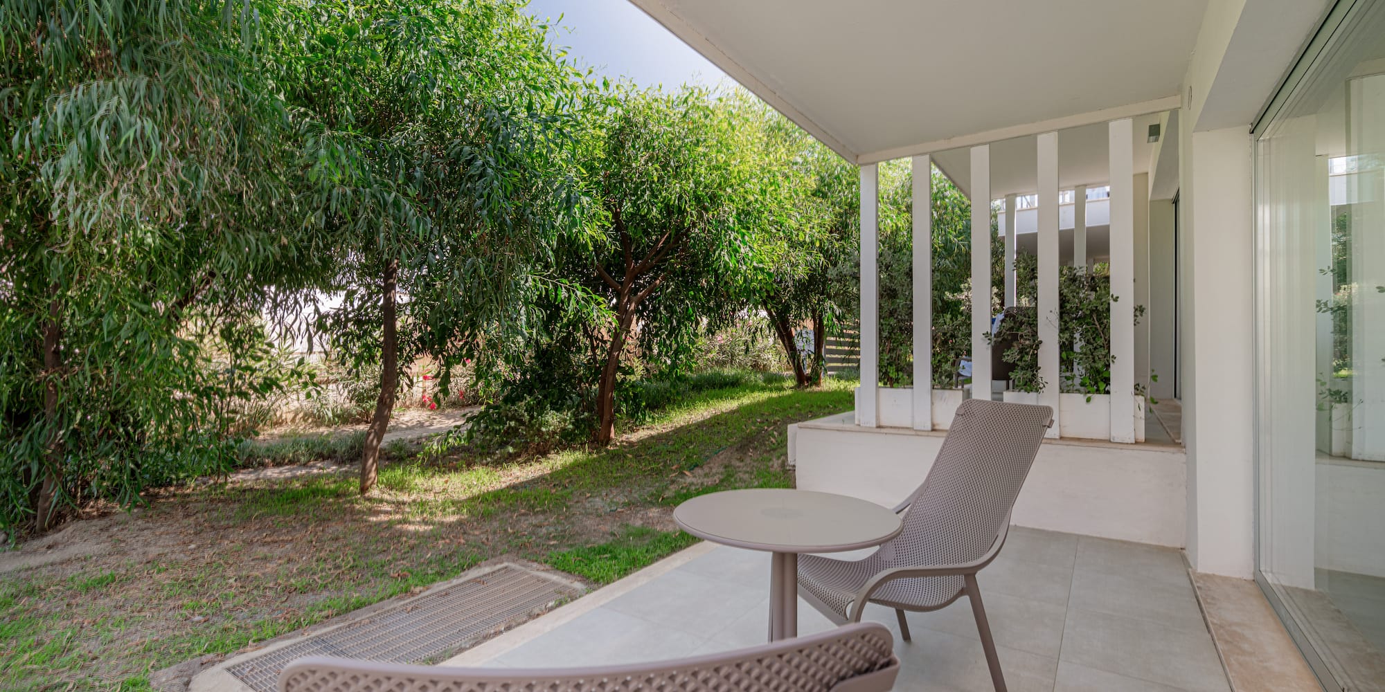 a patio with chairs and a table