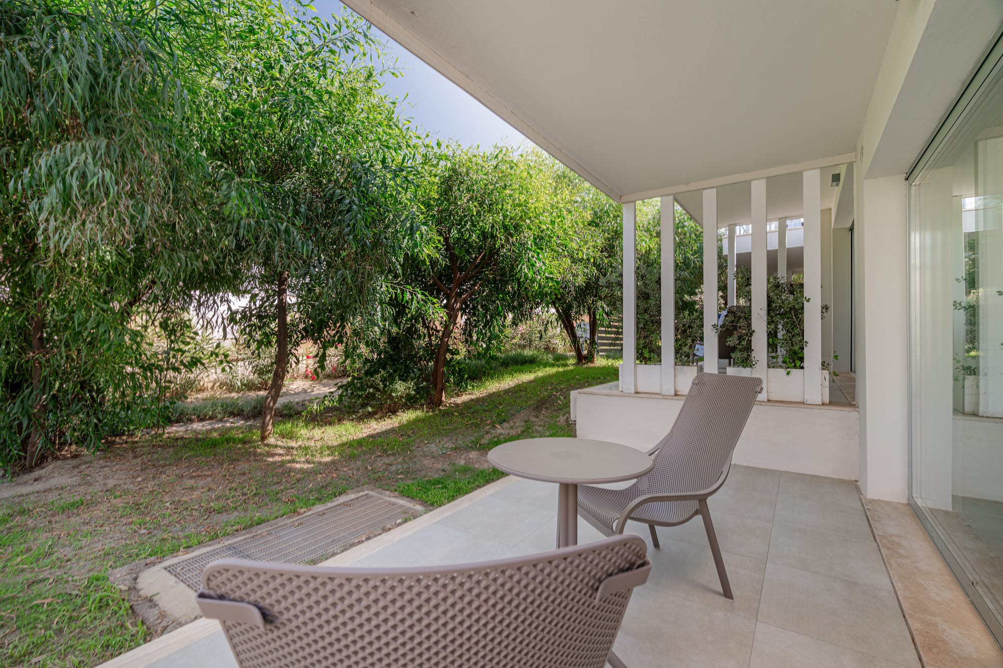 a patio with chairs and a table