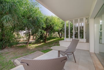 a patio with chairs and a table