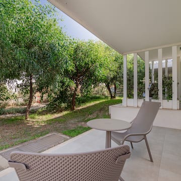 a patio with chairs and a table