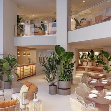 a room with tables and chairs and plants