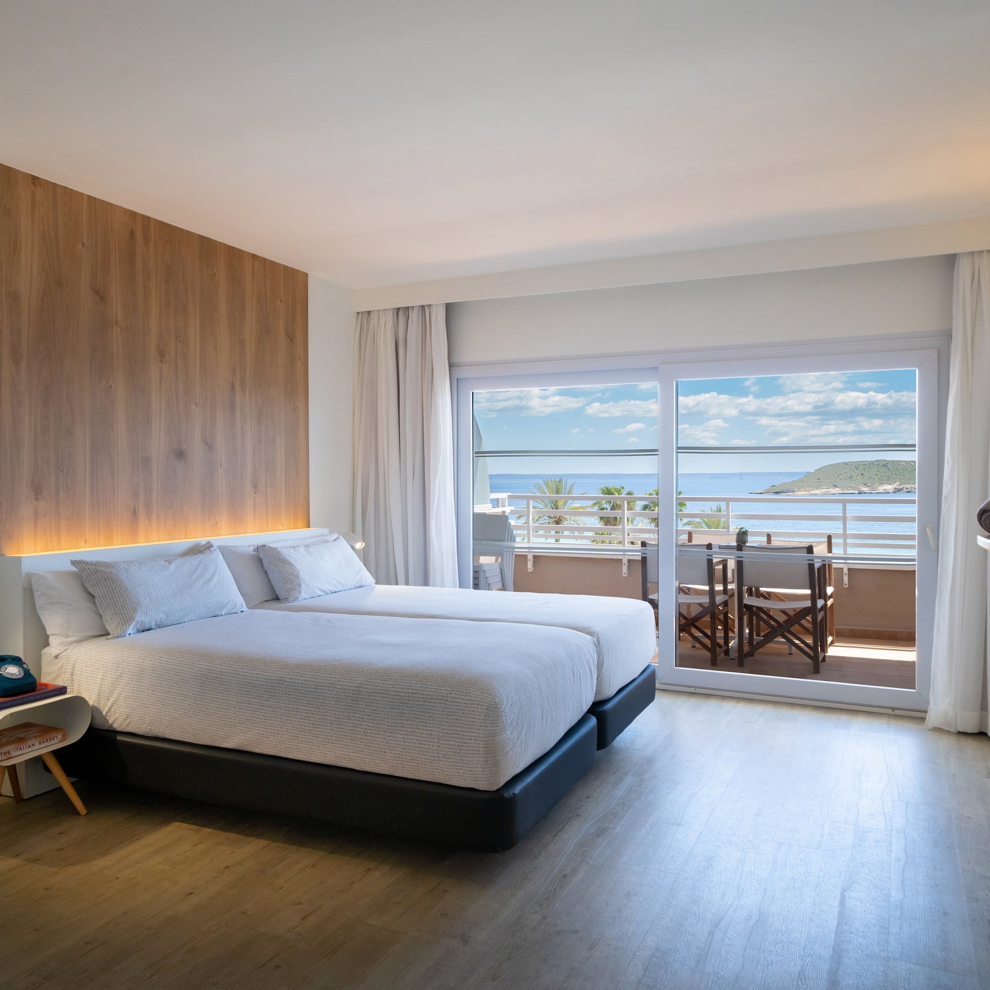 a bedroom with a large bed and a glass door