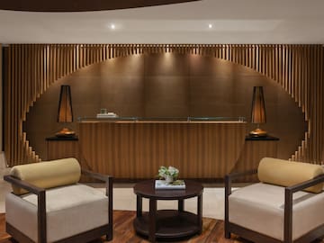 a reception desk with chairs and a table