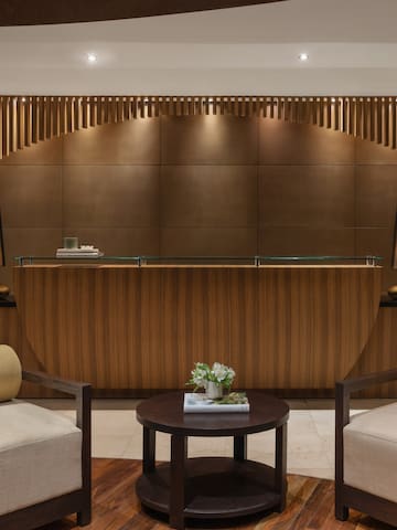 a reception desk with chairs and a table