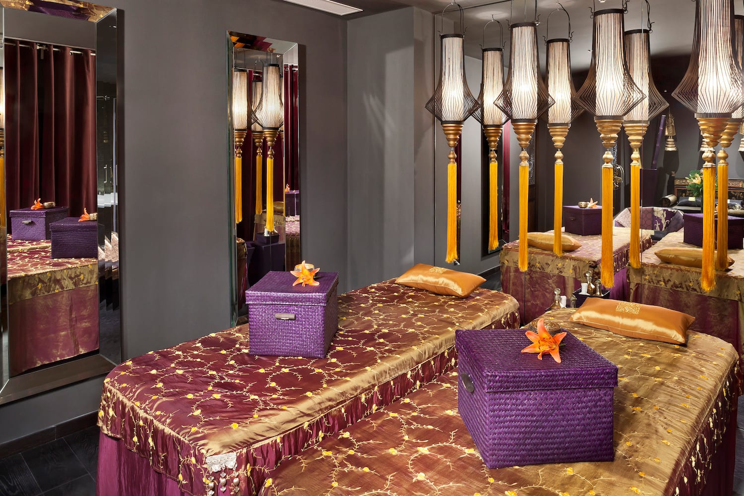 a room with purple and gold bedding