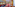 Hotel bar and lounge: dark wood bar, red seating, rich patterned carpet.
