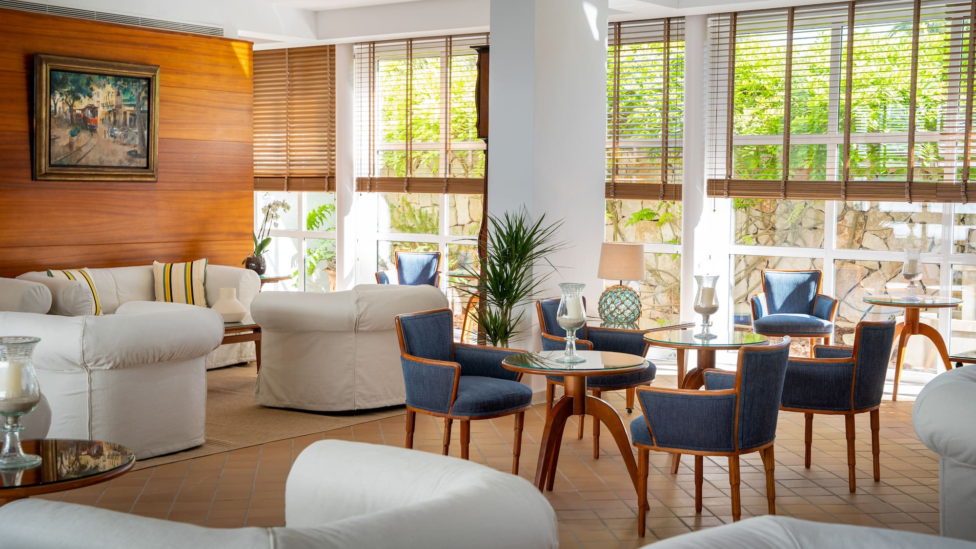 a room with white furniture and blue chairs