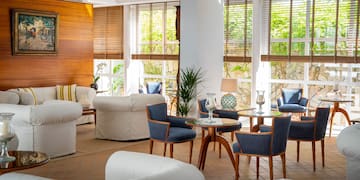 a room with white furniture and blue chairs
