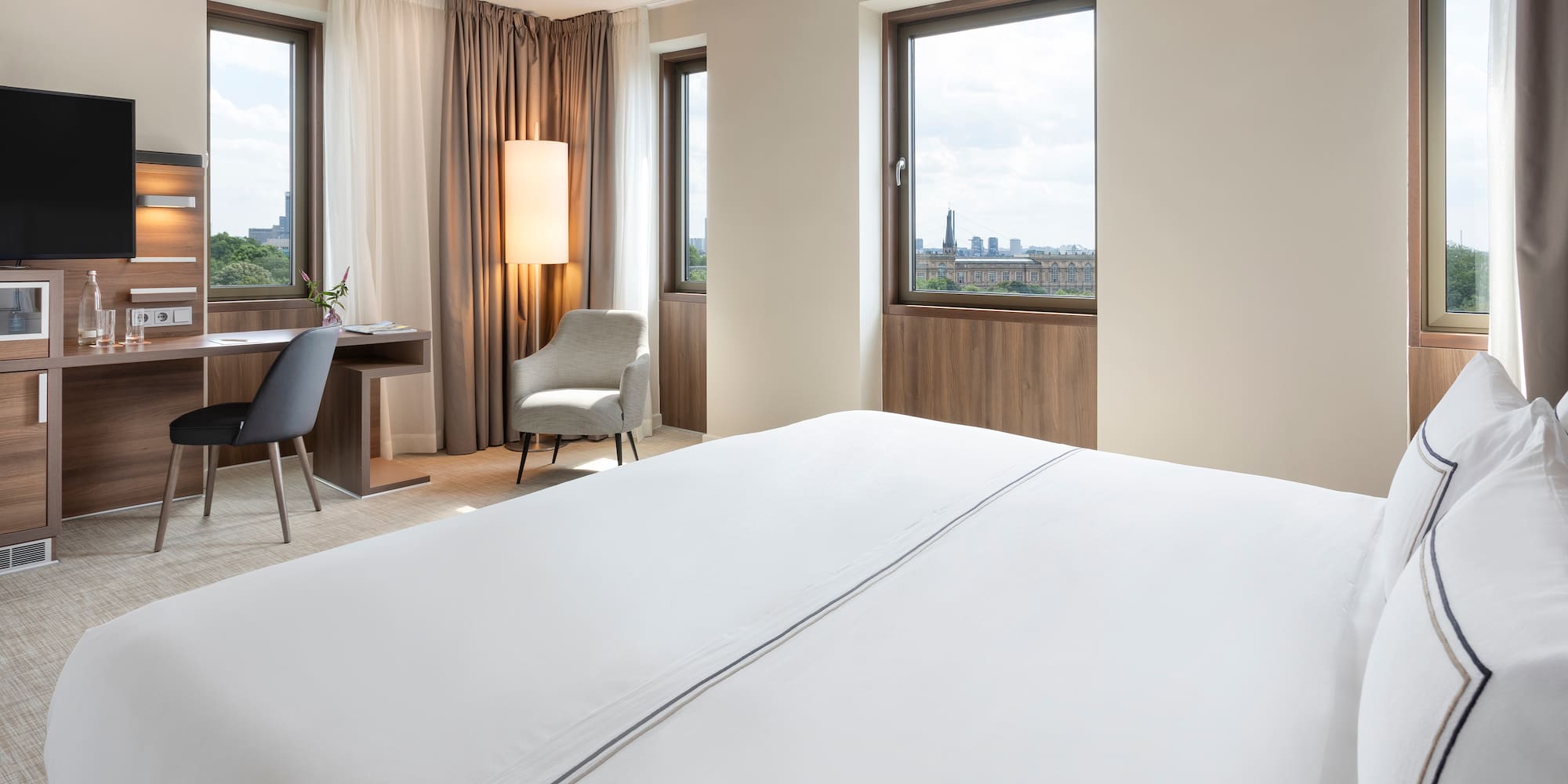 a room with a bed and a desk and chair