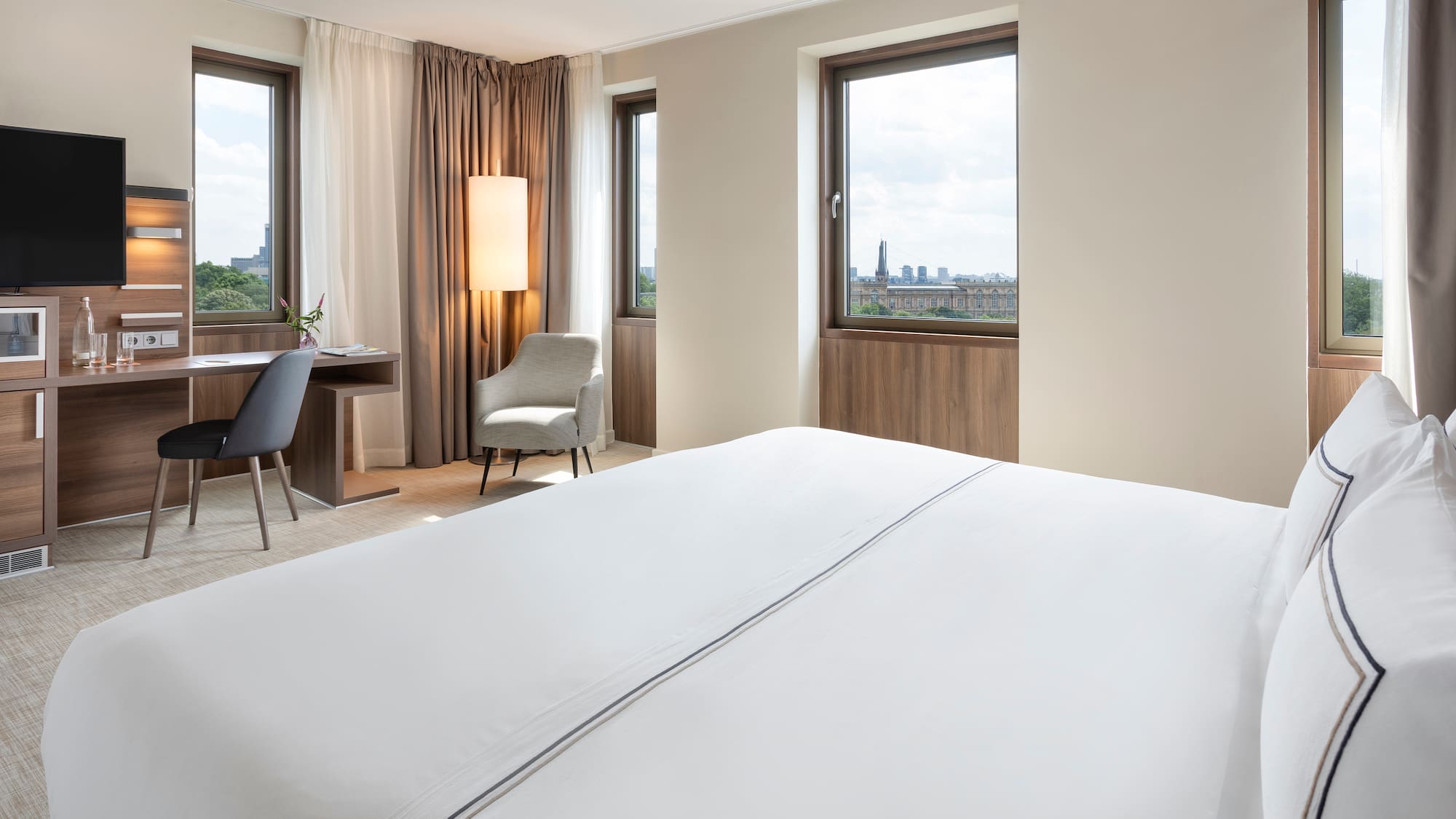 a room with a bed and a desk and chair