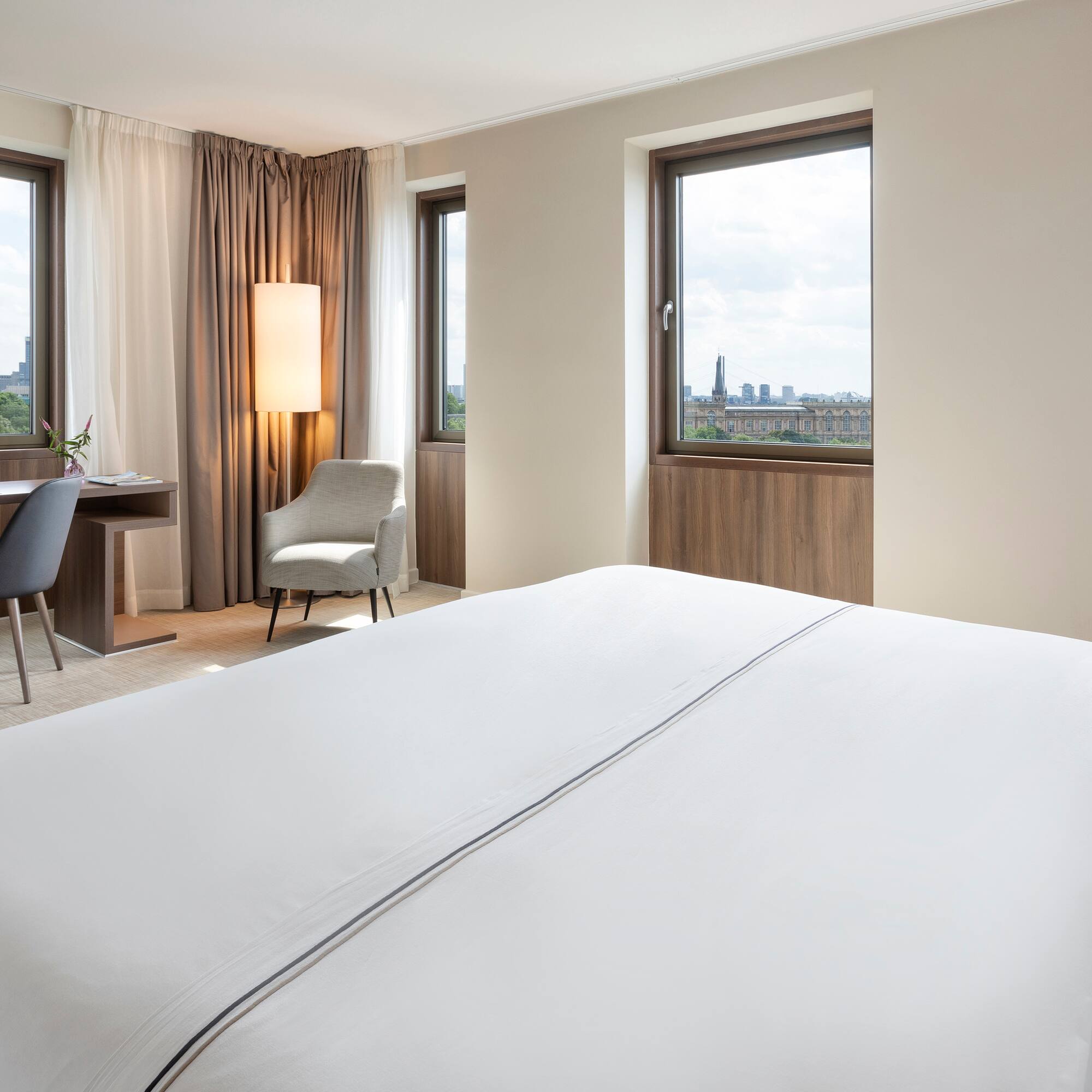 a room with a bed and a desk and chair