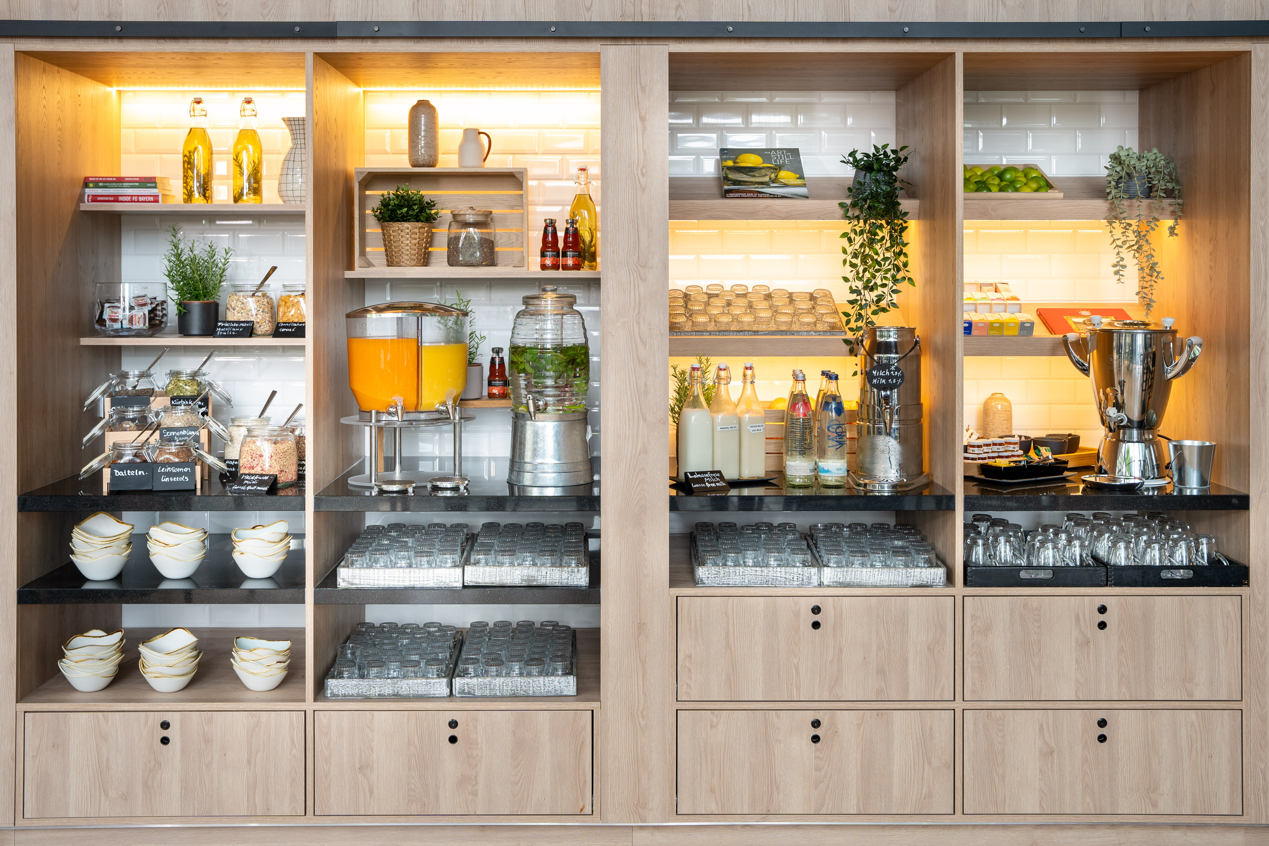 Hotel breakfast buffet with cereals, fresh juices, milk, and various beverages.