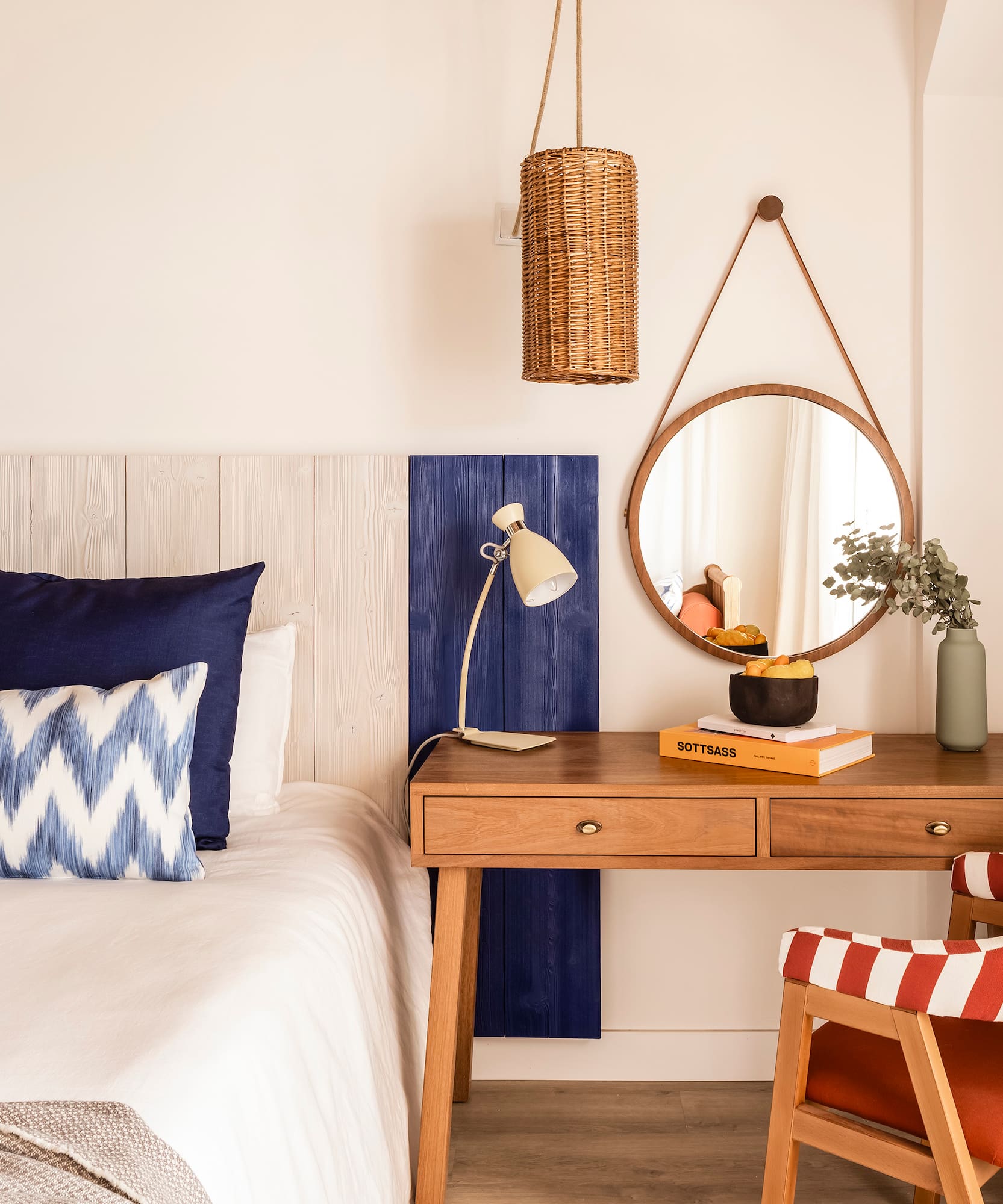 a bedroom with a desk and a mirror