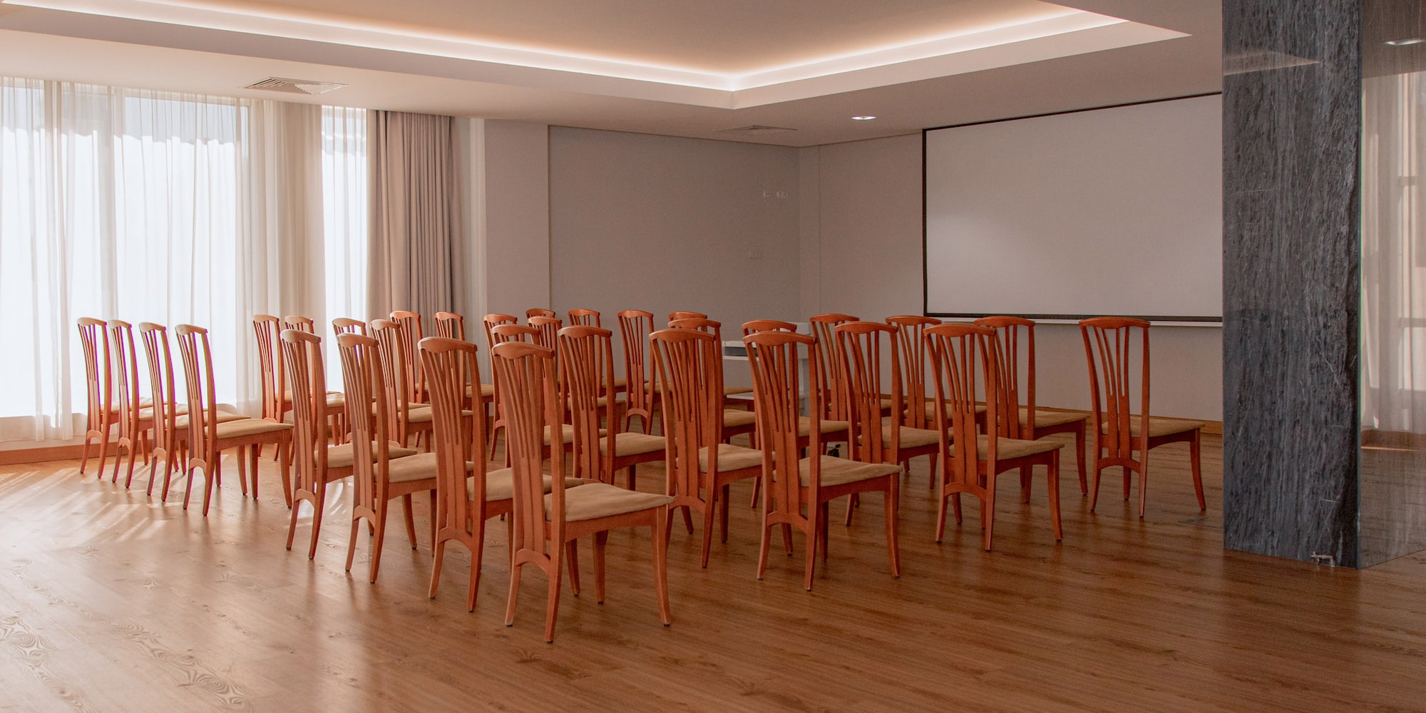 a room with chairs and a projector screen