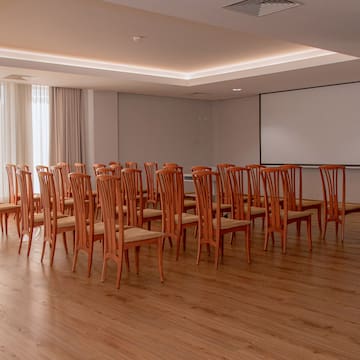 a room with chairs and a projector screen