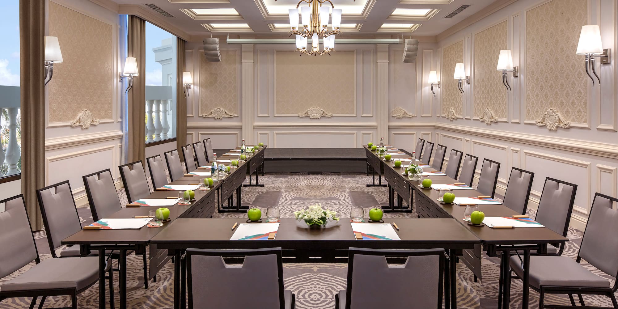 a room with long tables and chairs