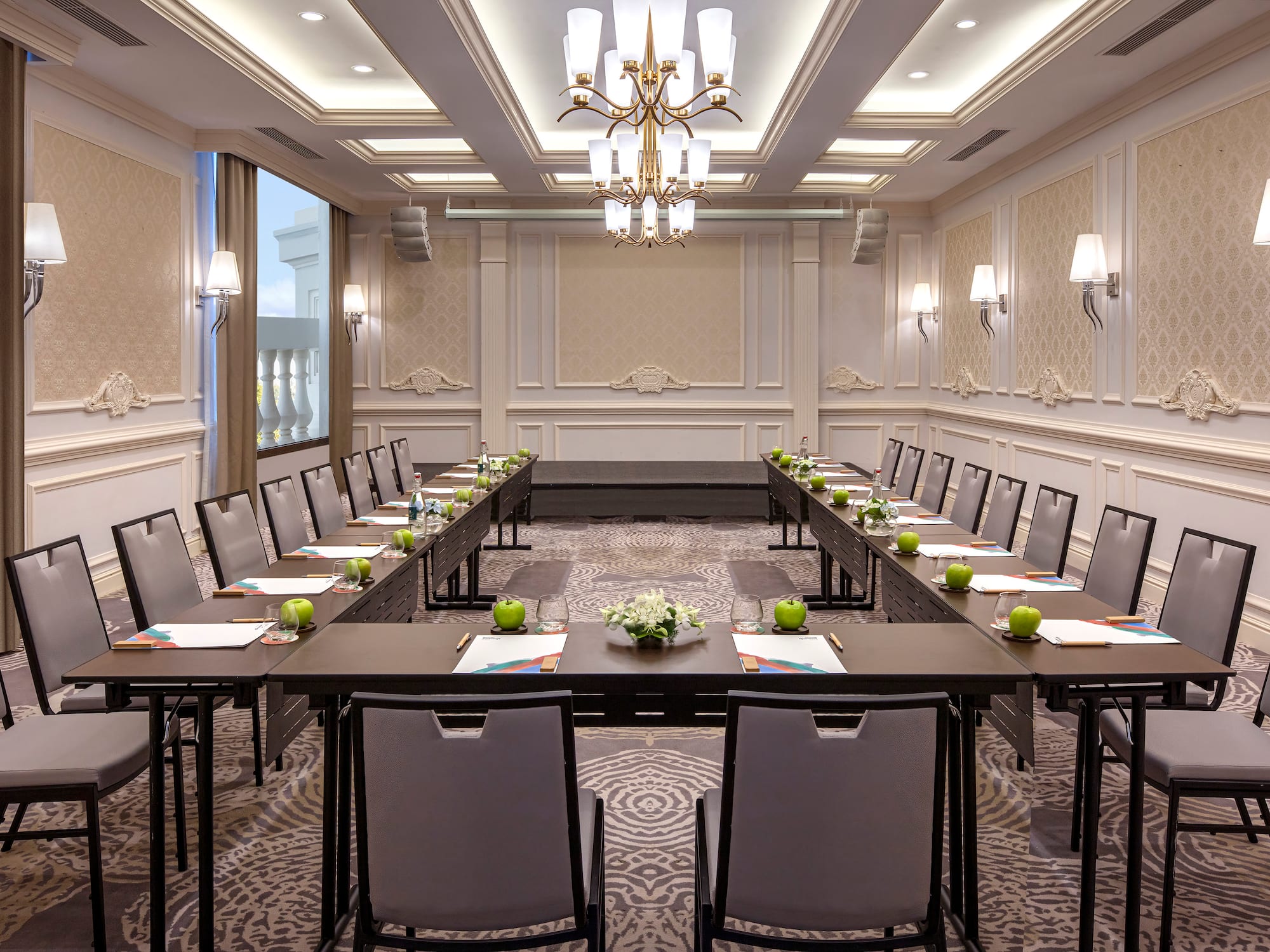 a room with long tables and chairs