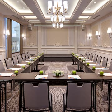 a room with long tables and chairs