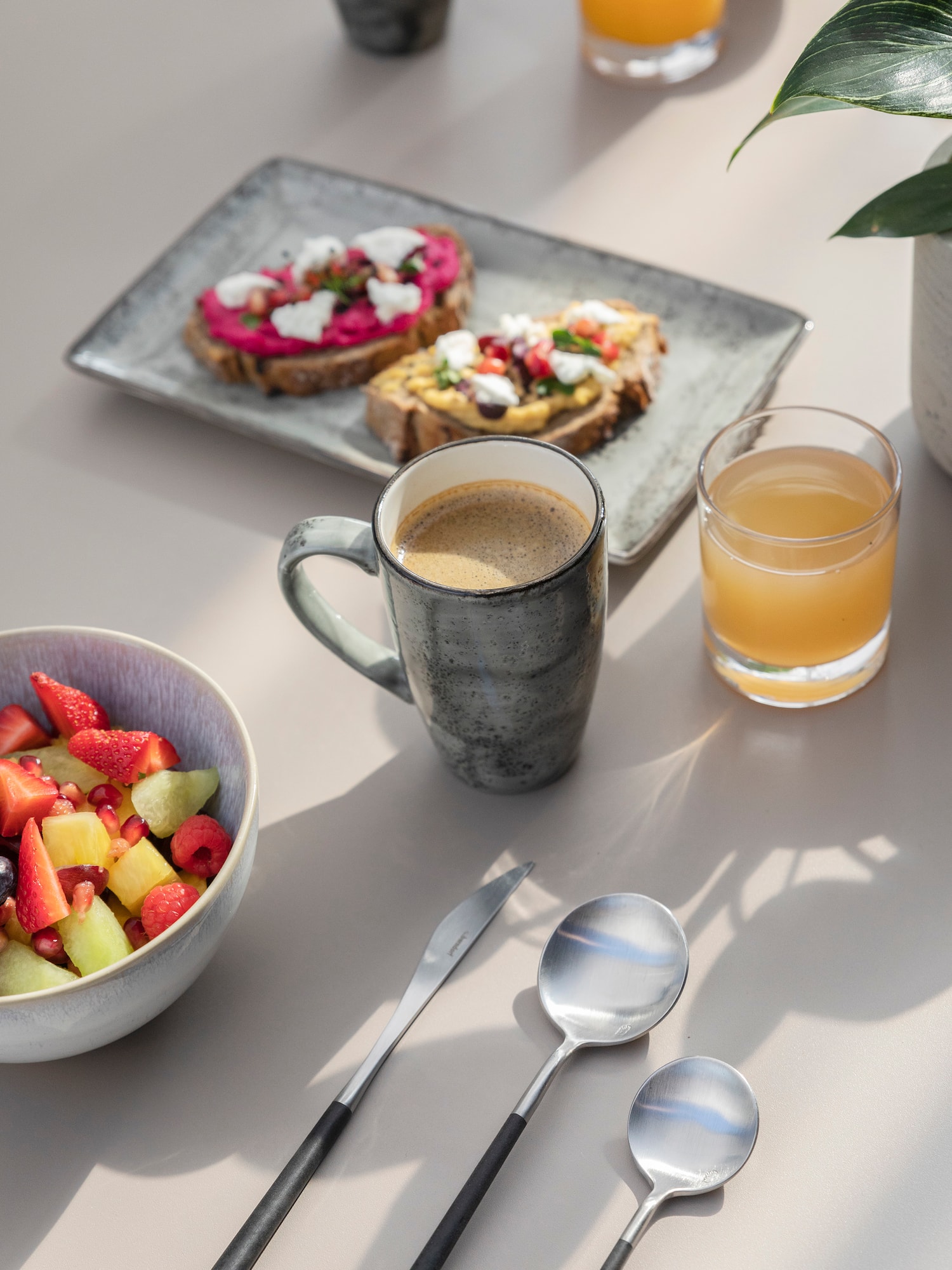 a table with food and a cup of coffee