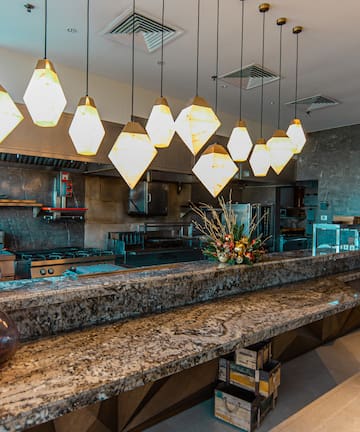 a kitchen with a counter and lights