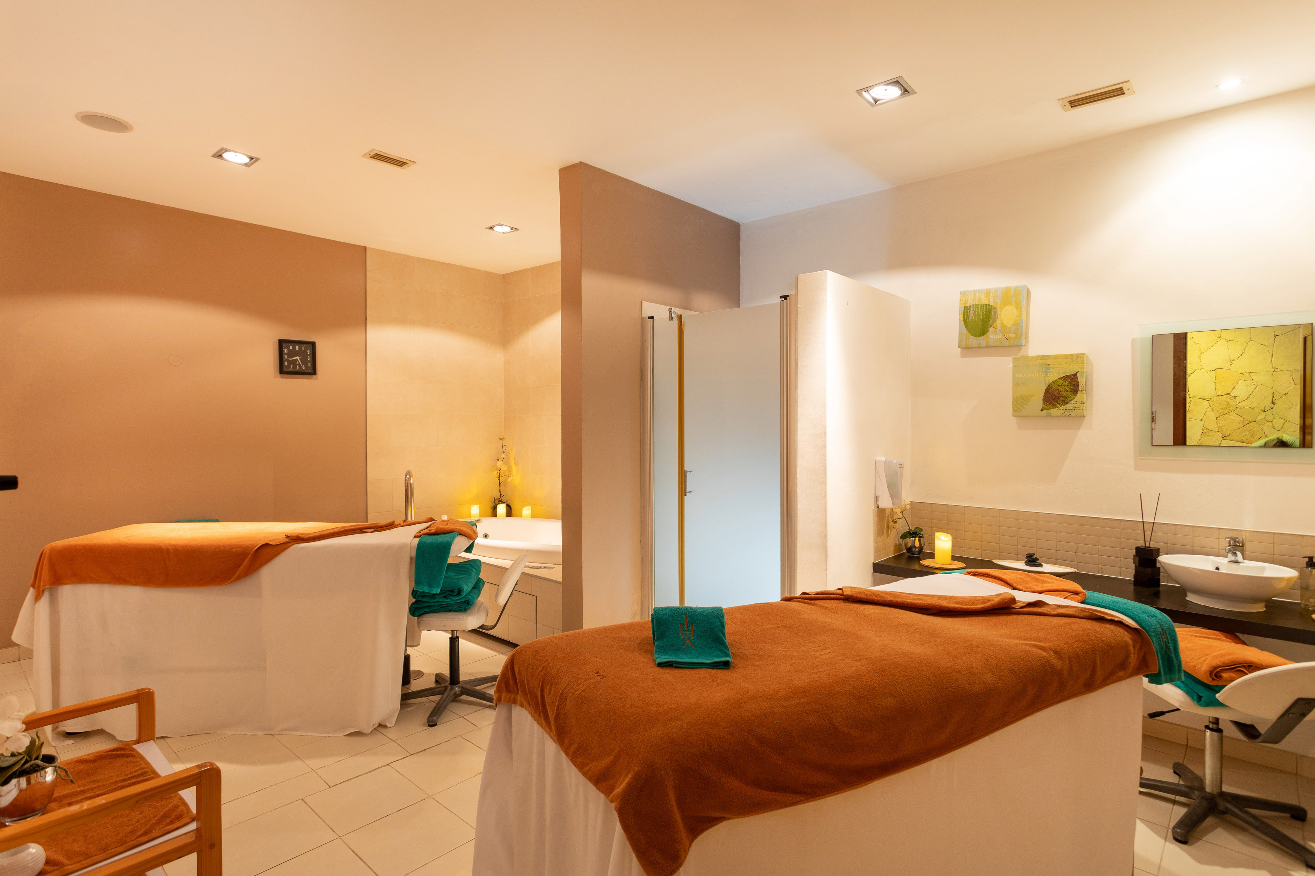 a room with beds and chairs