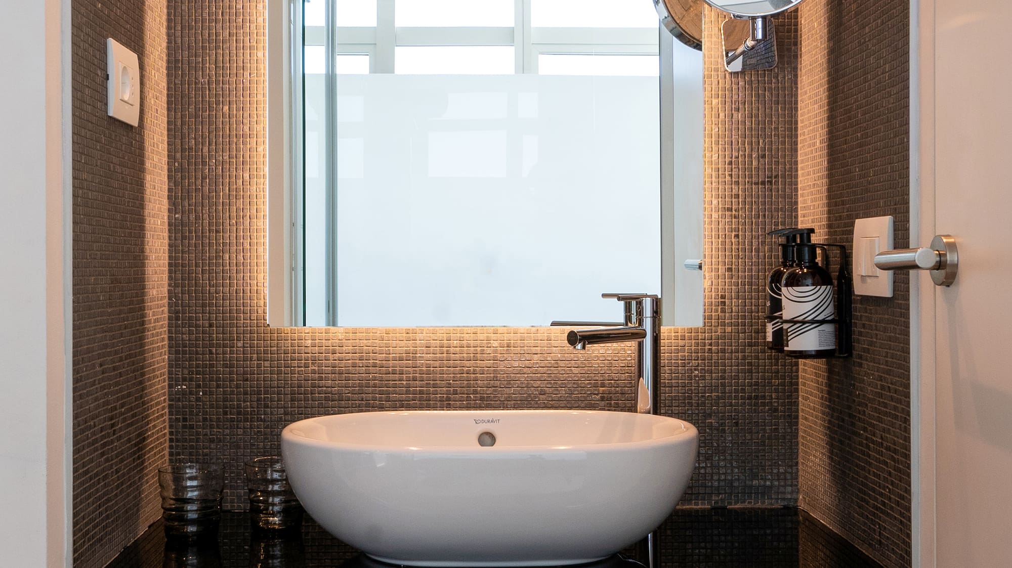 a bathroom with a sink and mirror