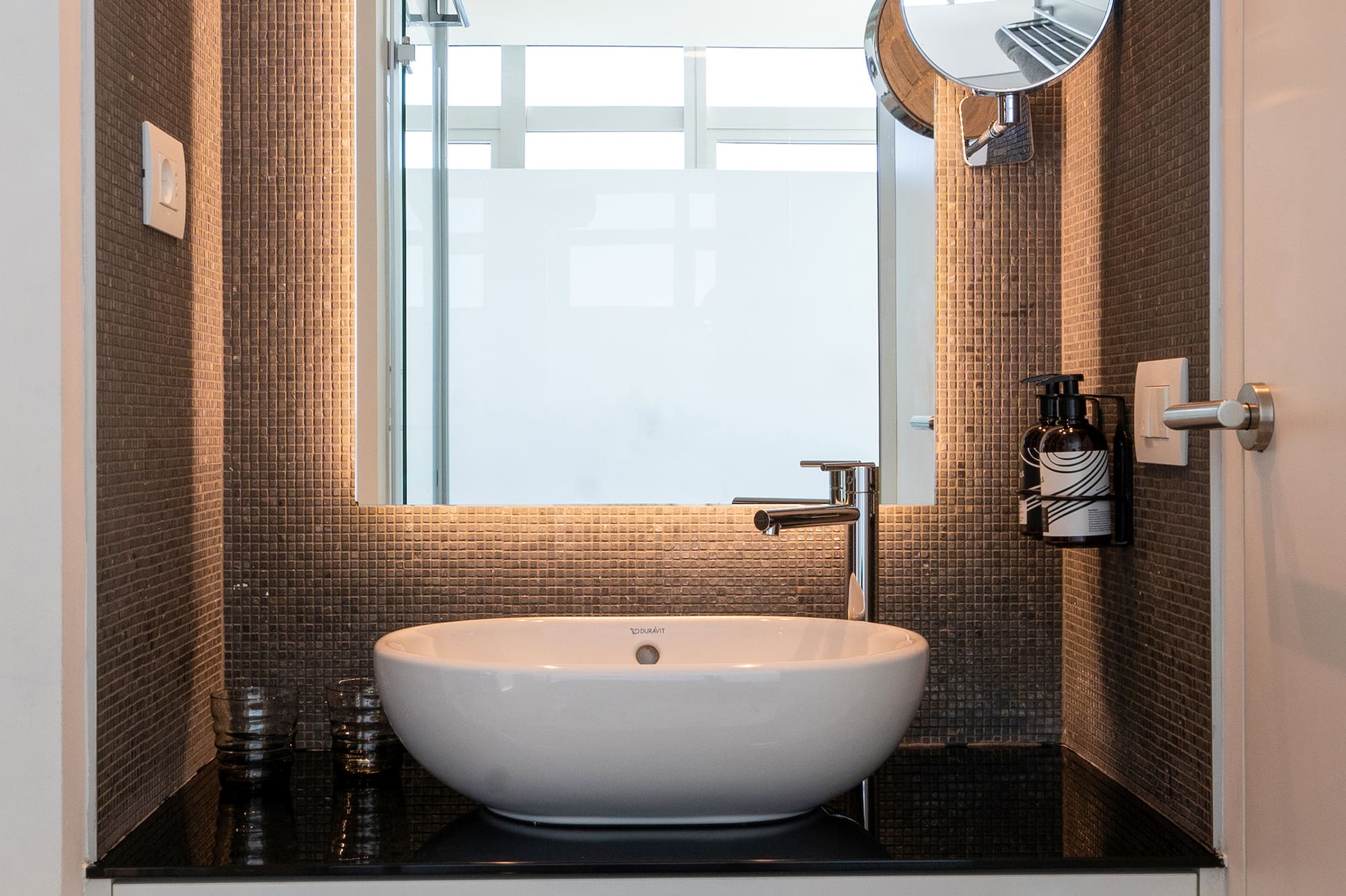 a bathroom with a sink and mirror