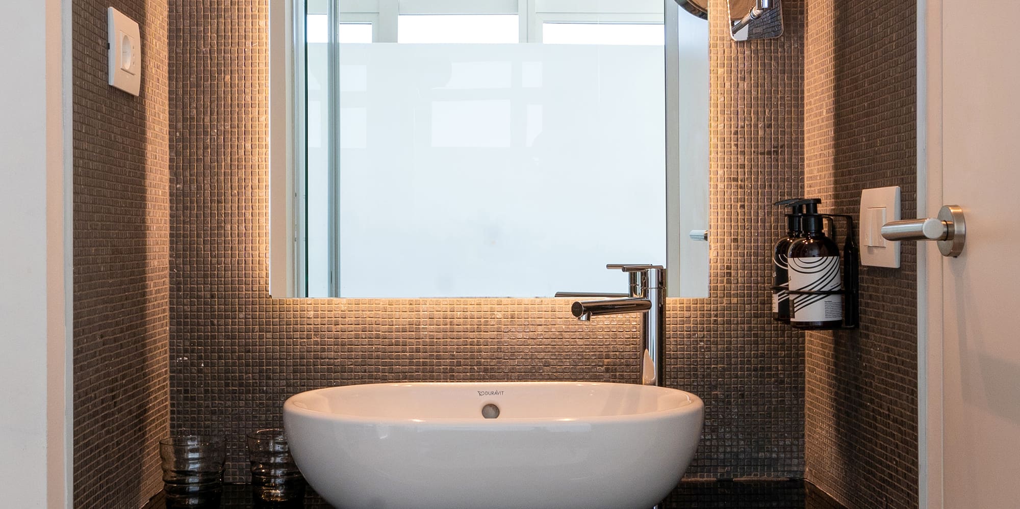 a bathroom with a sink and mirror