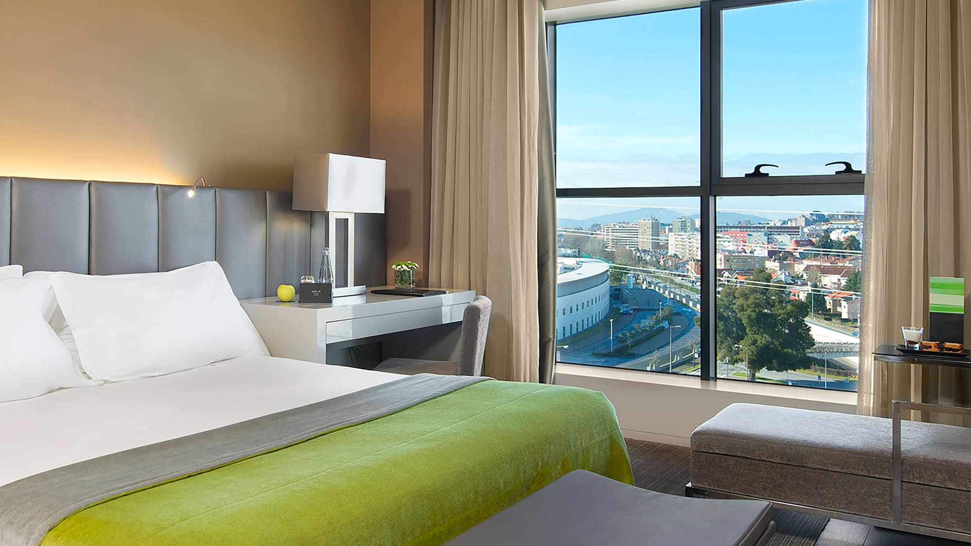 a bedroom with a large window and a bed