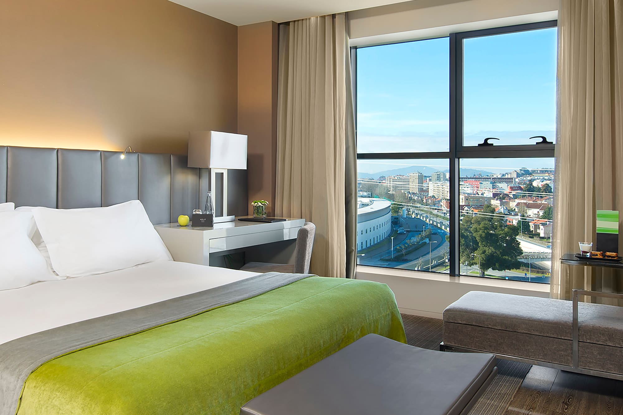 a bedroom with a large window and a bed