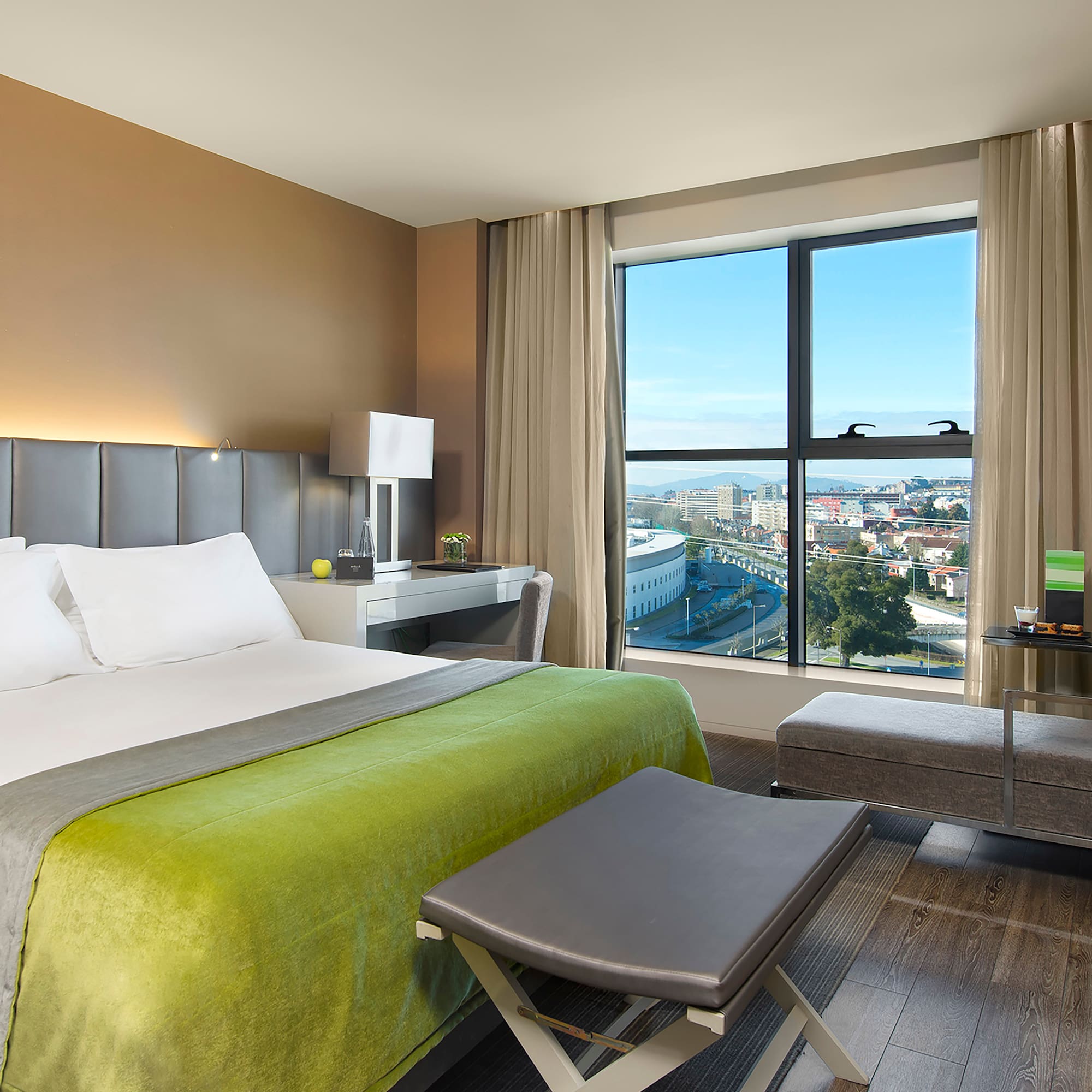 a bedroom with a large window and a bed