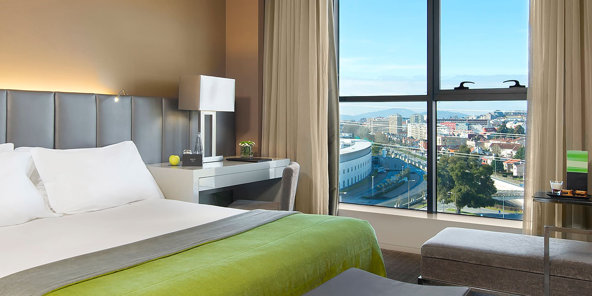 a bedroom with a large window and a bed