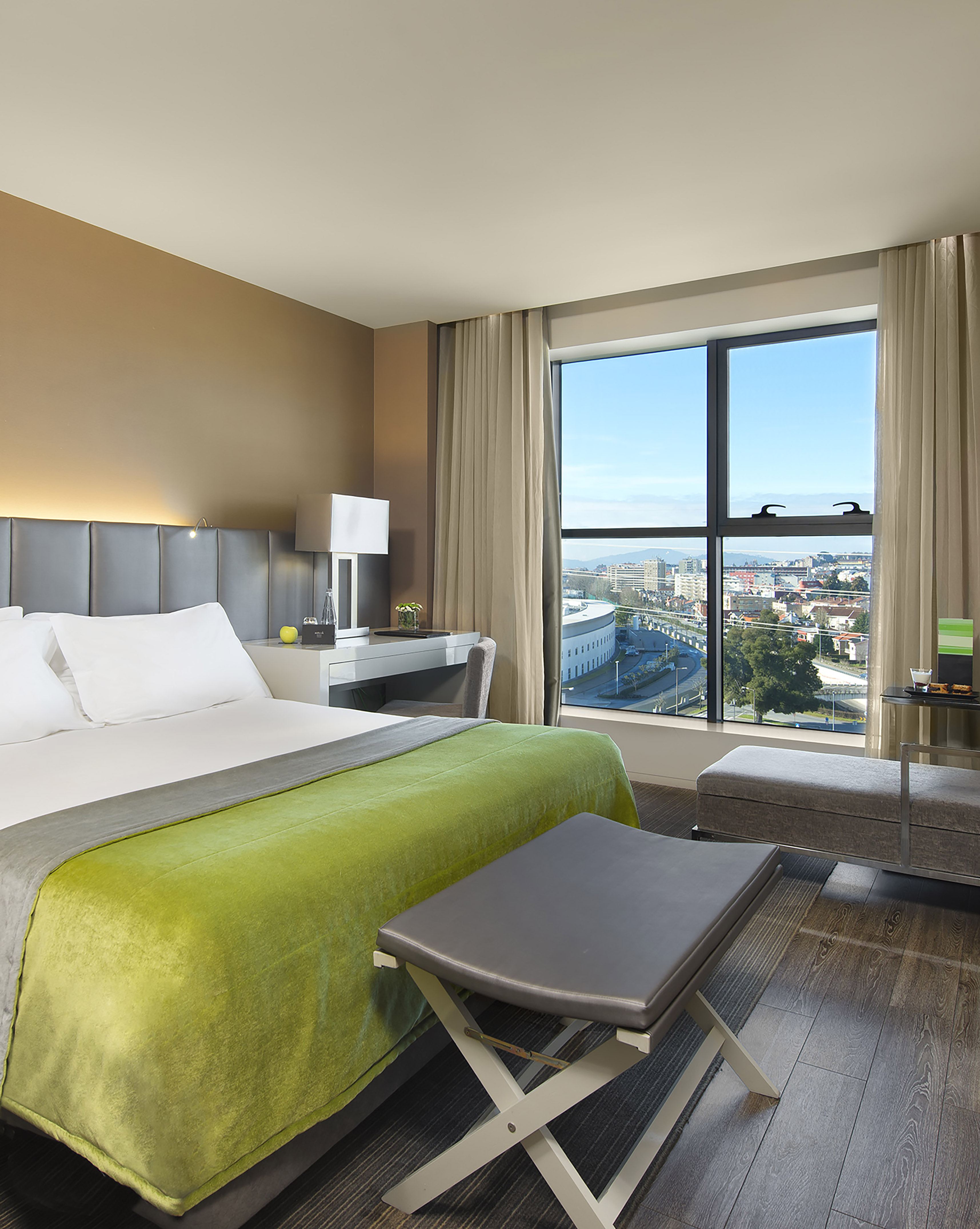 a bedroom with a large window and a bed