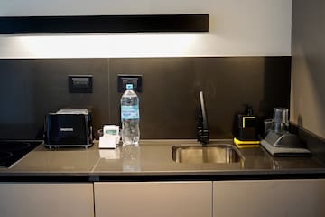 a kitchen counter with a sink and a bottle of water