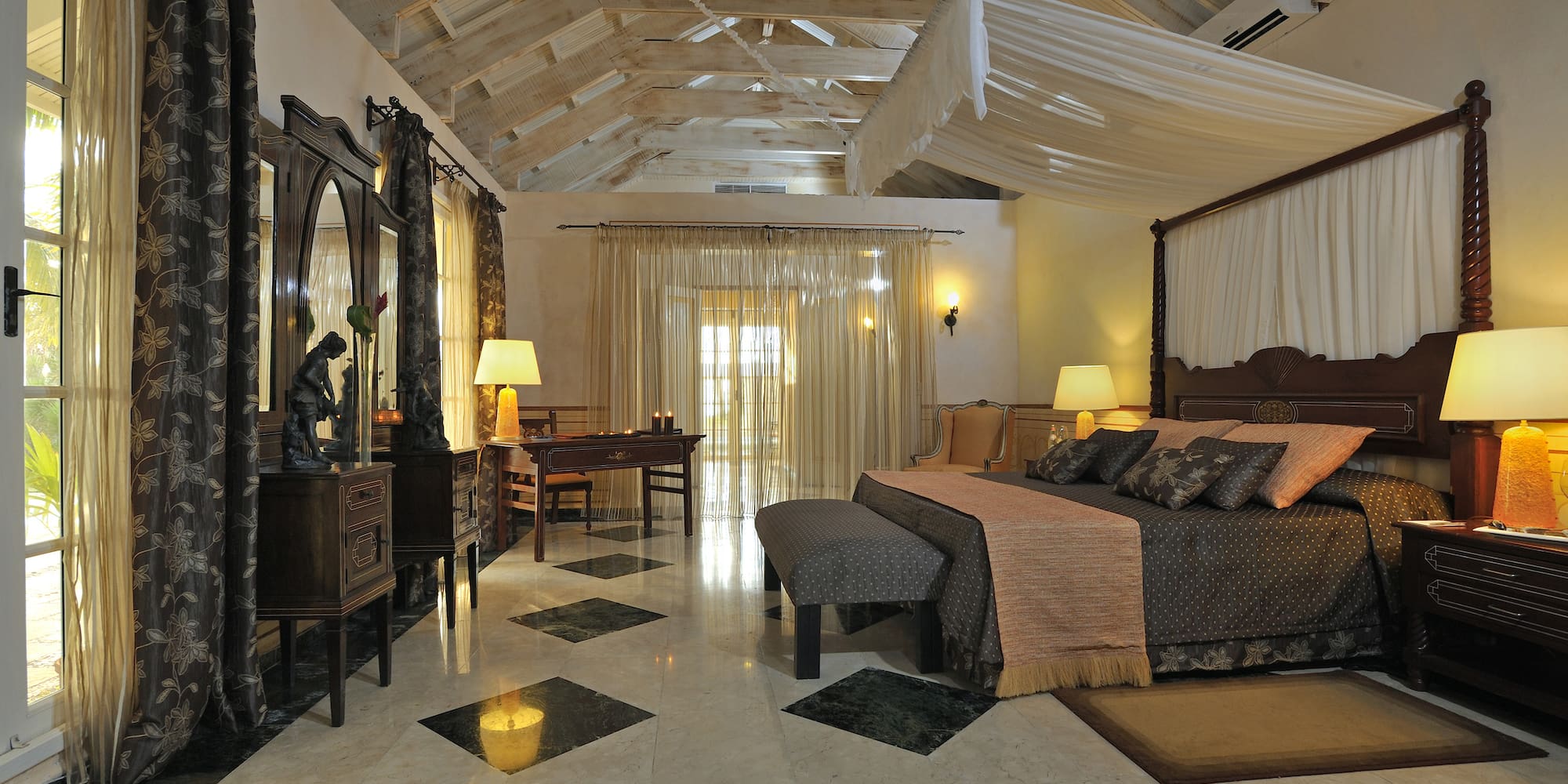 a bedroom with a large bed and a mirror