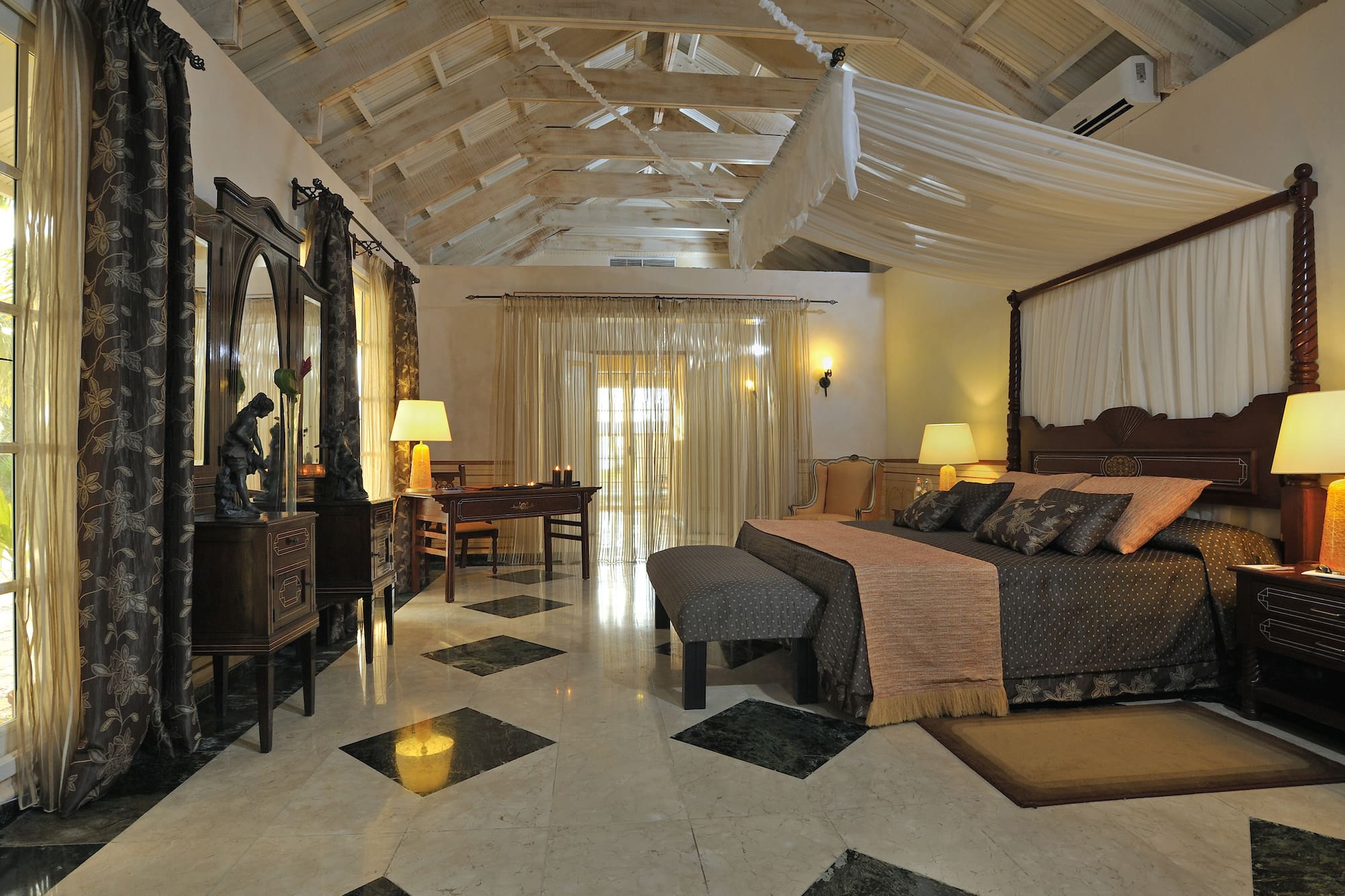 a bedroom with a large bed and a mirror