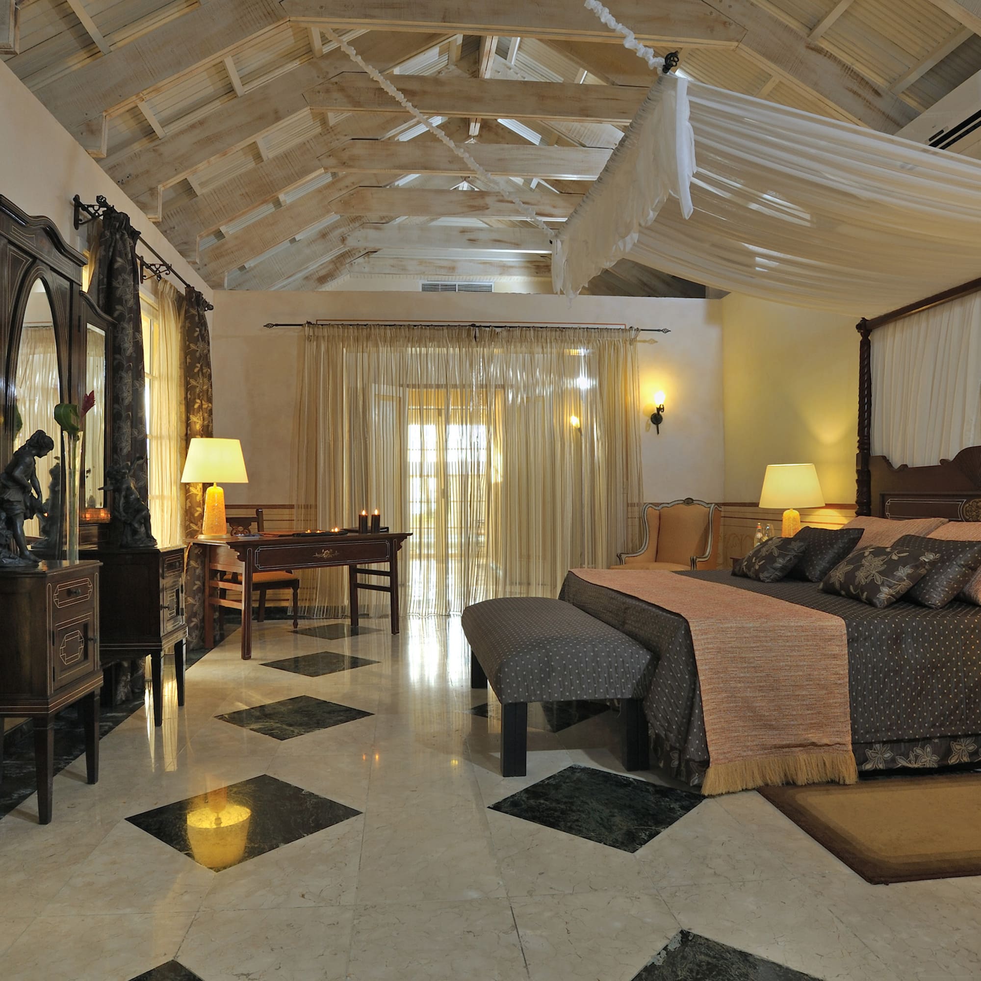 a bedroom with a large bed and a mirror