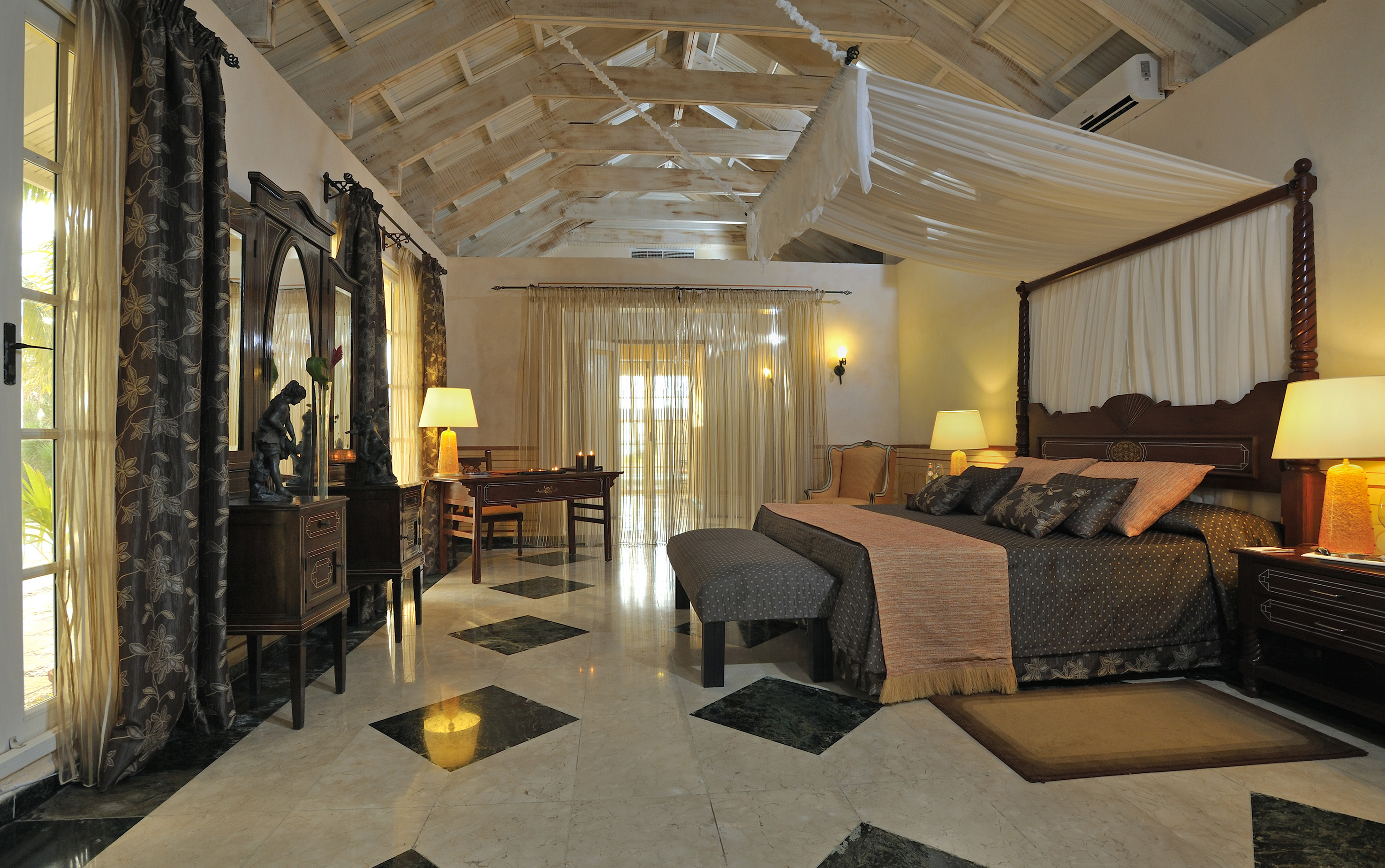 a bedroom with a large bed and a mirror