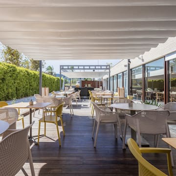 a patio with tables and chairs