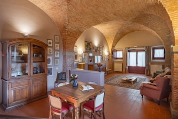 a room with a brick ceiling and a table and chairs