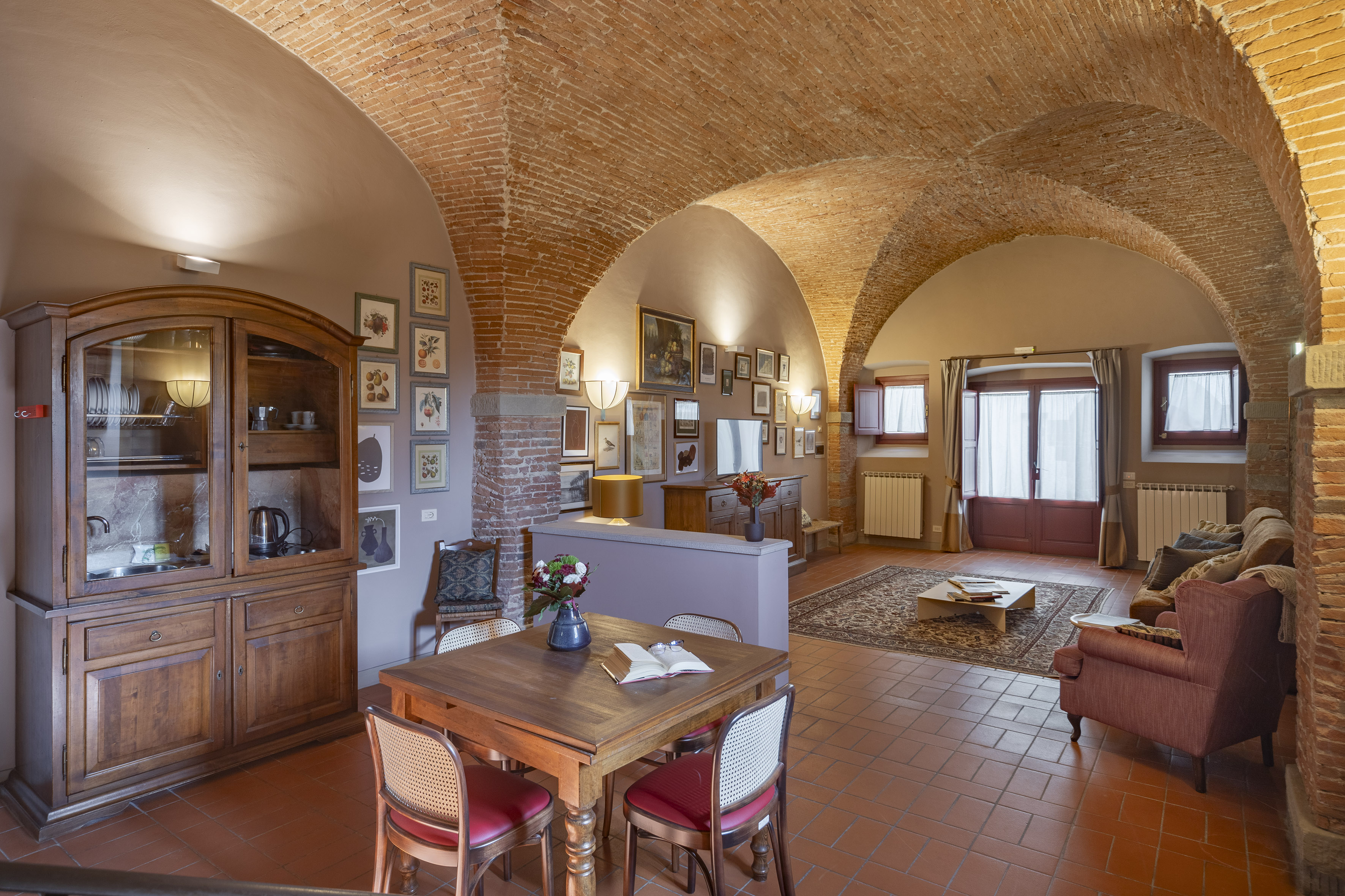 a room with a brick ceiling and a table and chairs