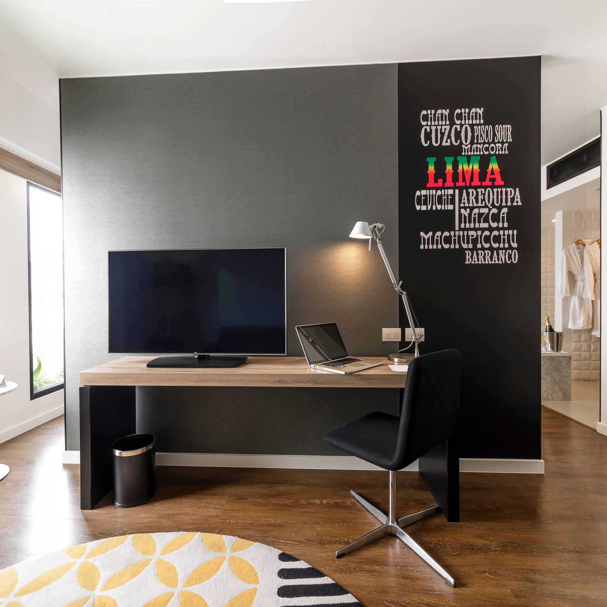 a room with a desk and a laptop