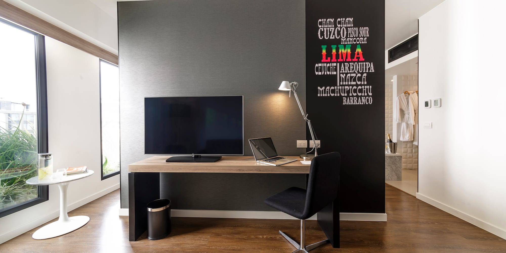 a room with a desk and a laptop