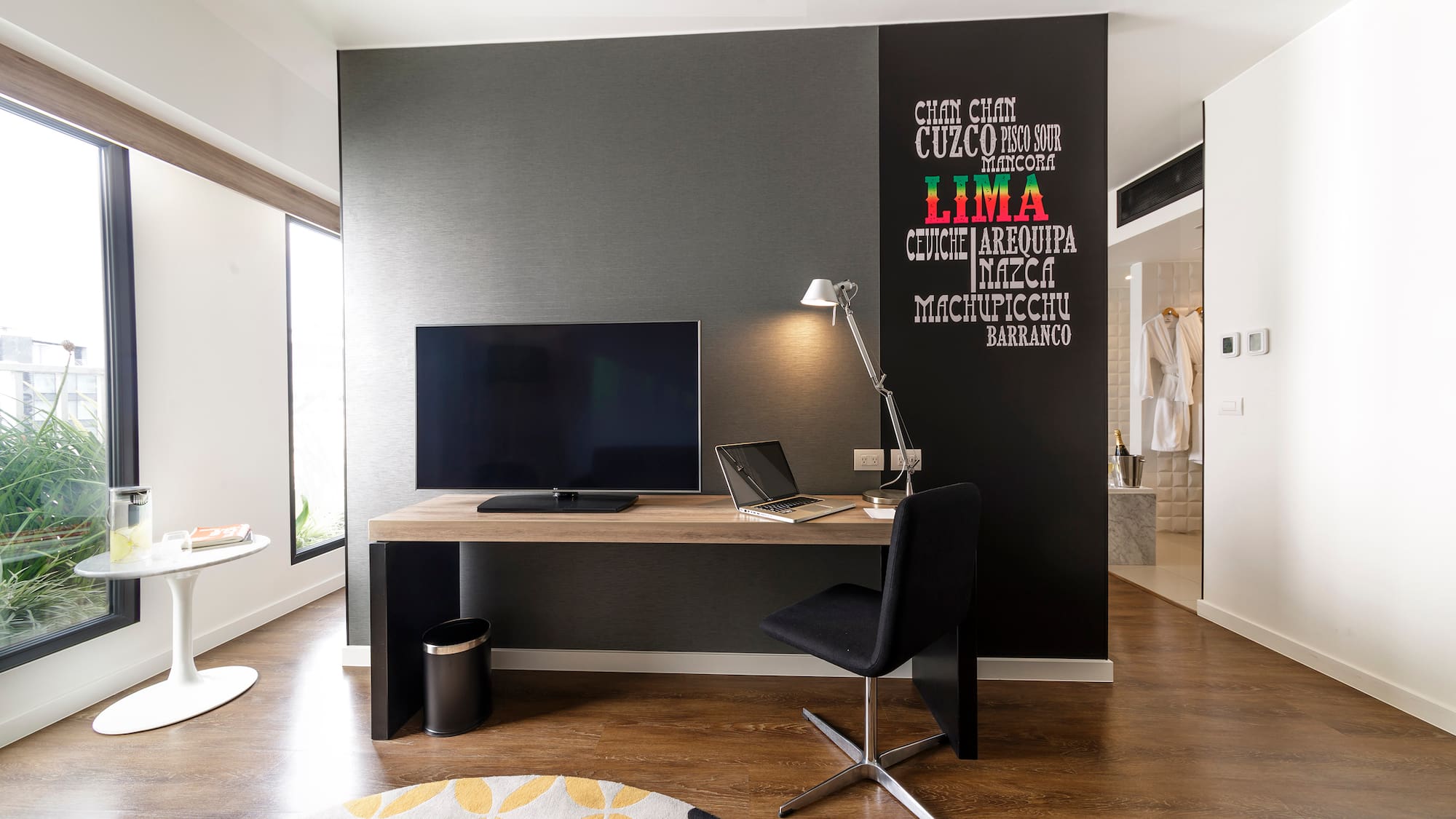 a room with a desk and a laptop