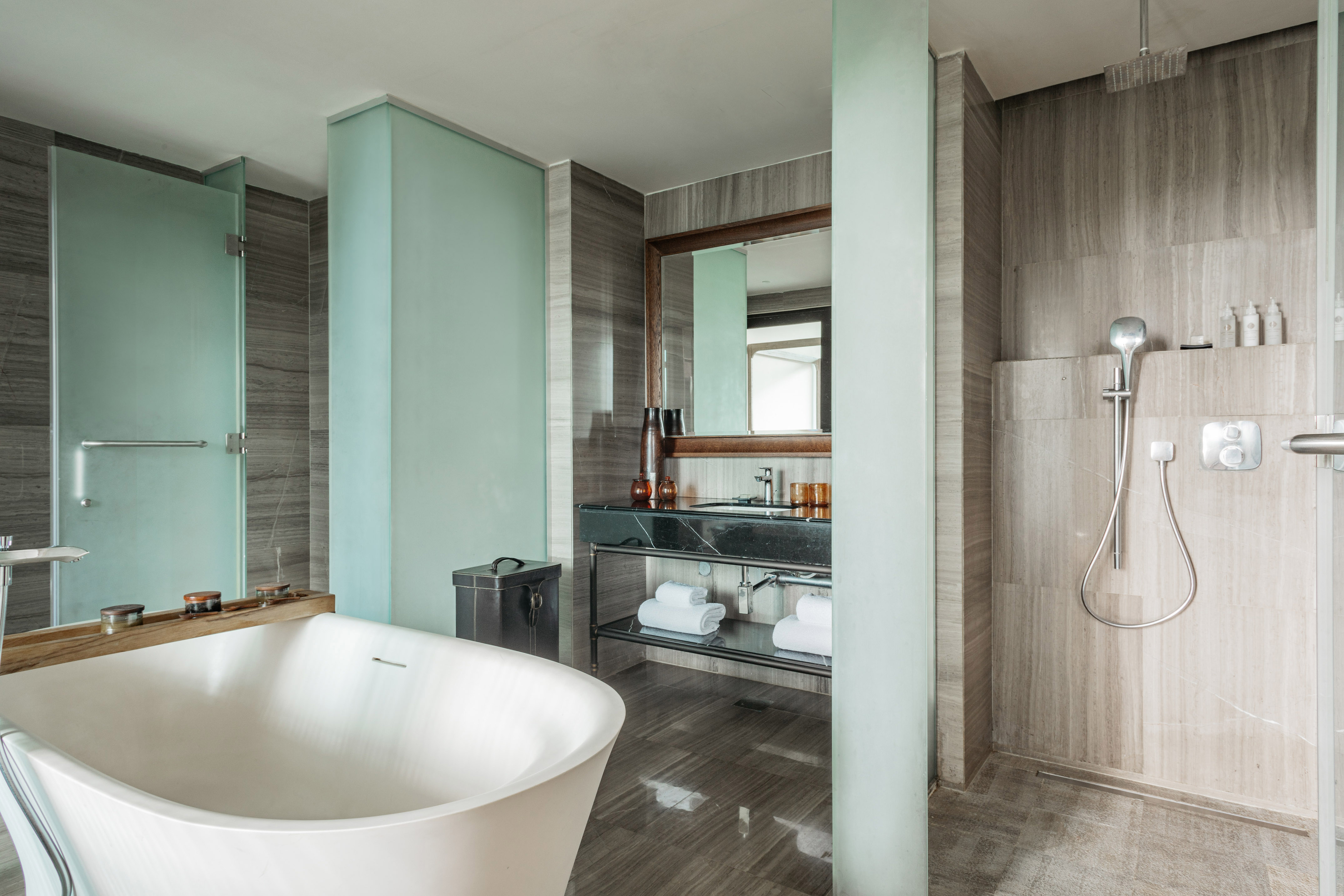 Sleek modern bathroom with freestanding bathtub, glass shower, and vanity.